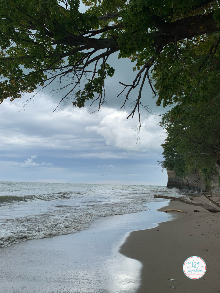 Water on the beach against a cliff wall