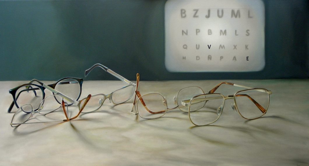 Miscellaneous glasses on a table in front of an eye chart